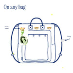 D-Ring Pins (2-Pack) by Pinbuds, on a bag front panel and strap