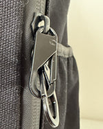 Cotton Convertible ITA Bag 15", black: close-up of the anti-theft lobster clasp on the pin window zip pulls