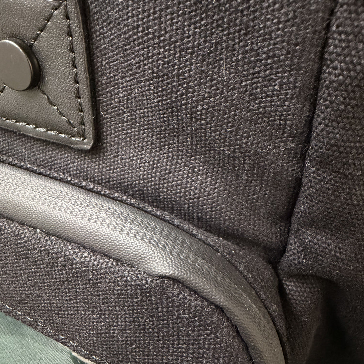 Cotton Convertible ITA Bag 15", black: close-up of the 12oz cotton, water-resistant zip and vegan leather tab