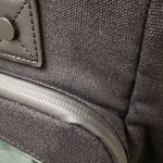 Cotton Convertible ITA Bag 15", black: close-up of the 12oz cotton, water-resistant zip and vegan leather tab