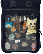 Cotton Convertible ITA Bag 15", black: close-up of the pin window filled with pins and charms, cut out