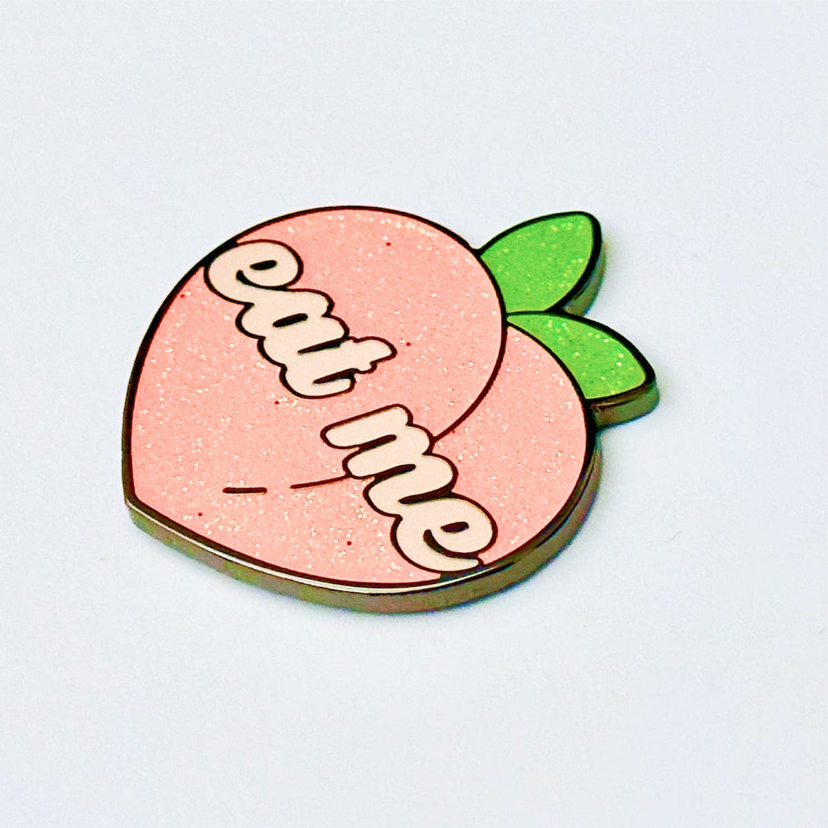 Eat Me Peach enamel pin, black plating