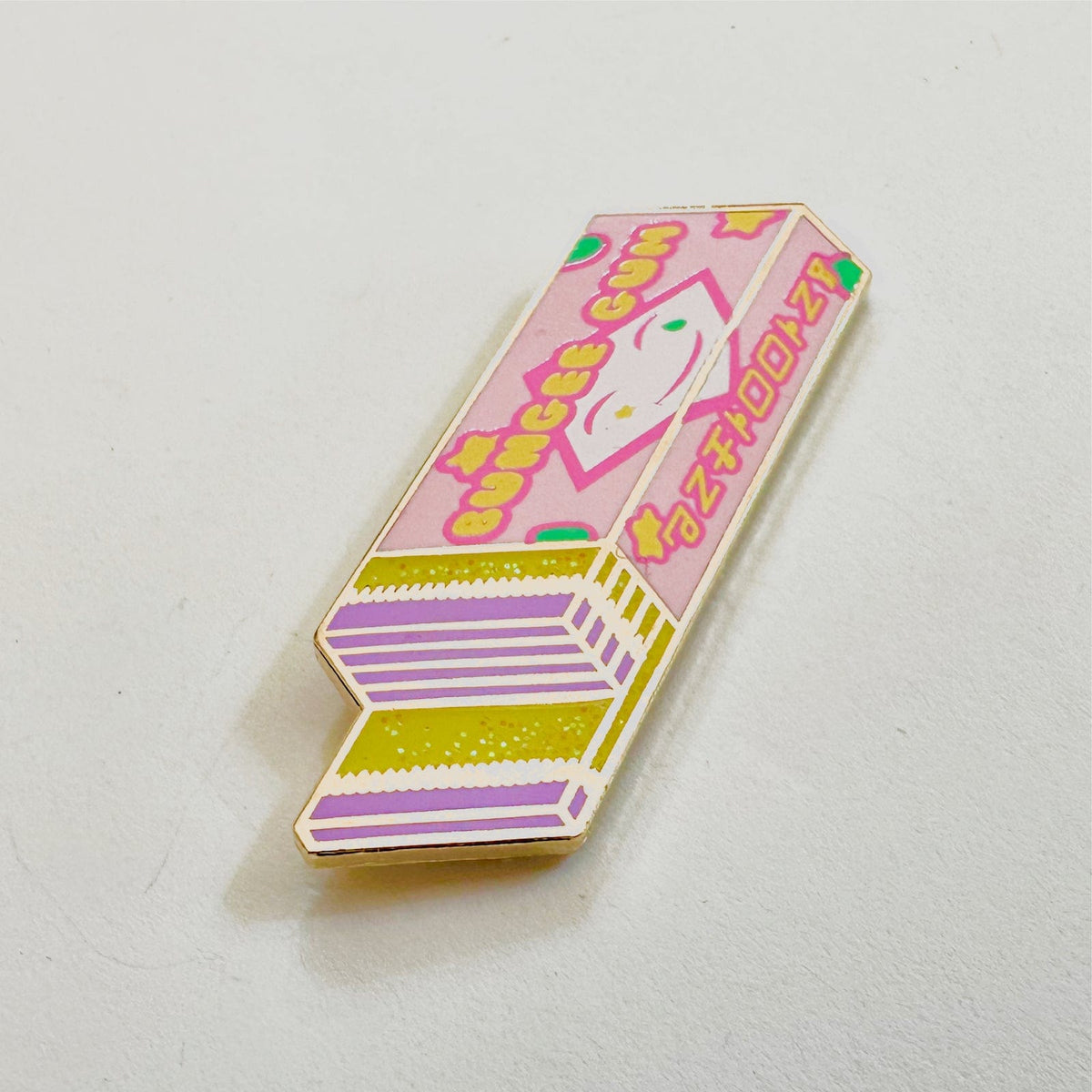 Bungee Gum Stick enamel pin, gold plating