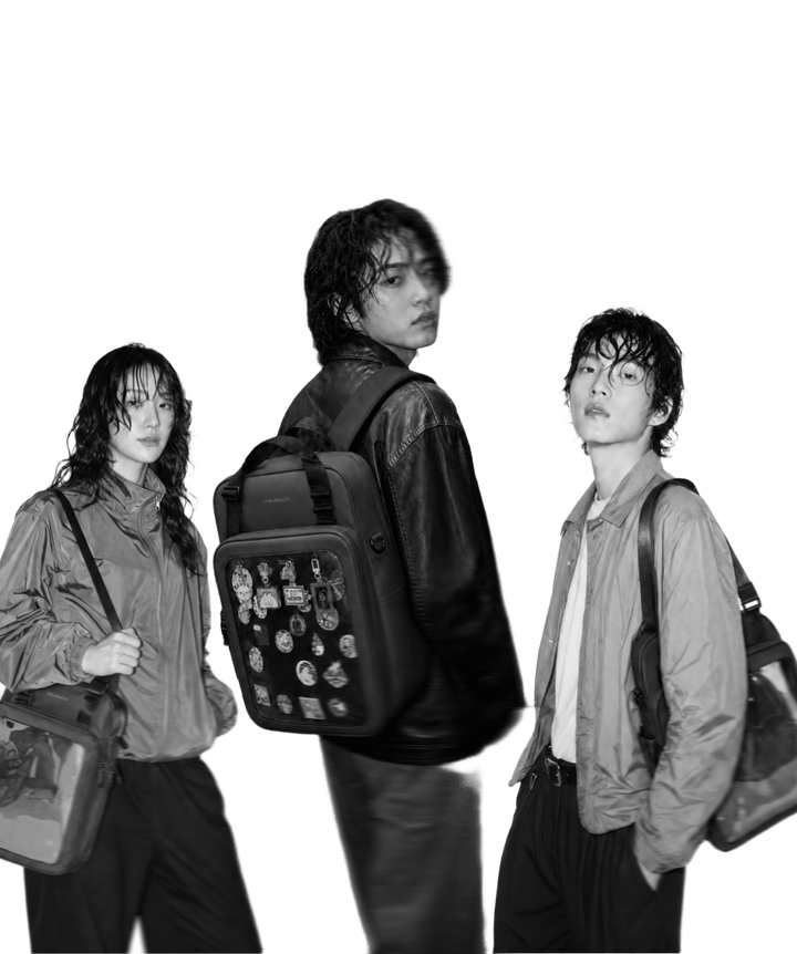 Three people carrying Pinbuds 4-Way ITA bags with pins on display
