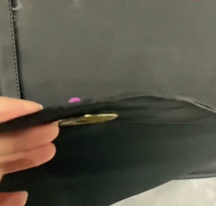 Pinning an enamel pin to a hook and loop pin pad for an ITA bag window