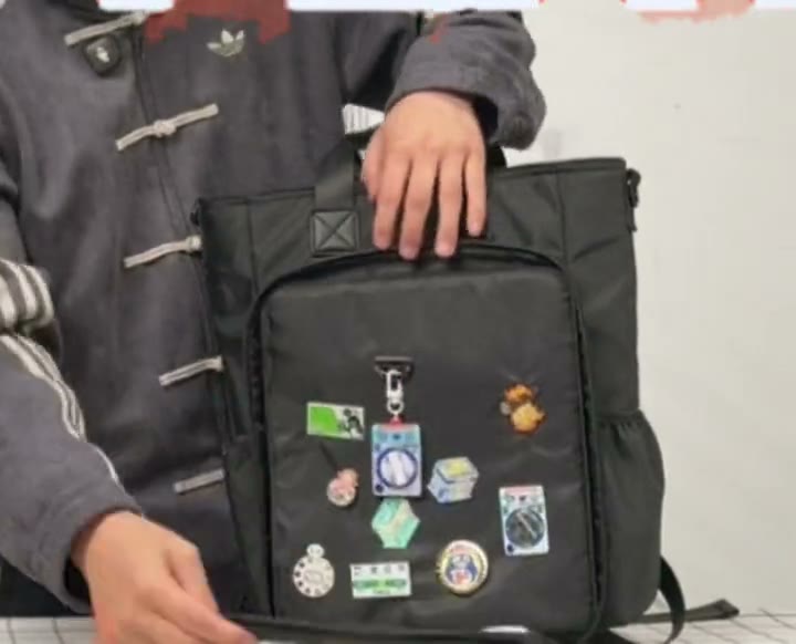 Opening the three-sided window zip of the 15 inch Cotton ITA bag to rearrange pins and charms