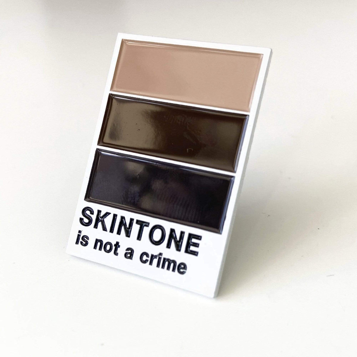 Skintone Is Not a Crime enamel pin, designed in Sydney